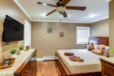 a bedroom with a bed with a ceiling fan at Private Hot Tub on 10 Acres Cozy Catskill Getaway in Catskill
