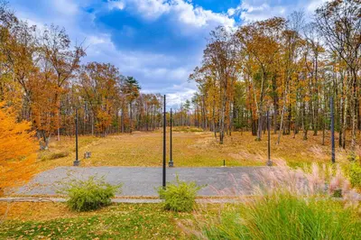 an empty parking lot with trees in the background at Private Hot Tub on 10 Acres Cozy Catskill Getaway in Catskill