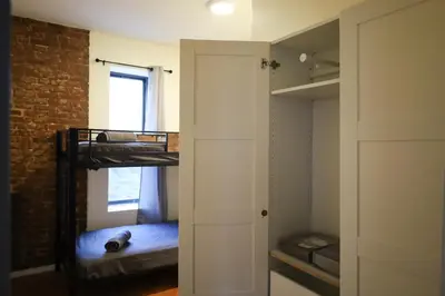 a room with two bunk beds and a closet at Family Friendly 4BR 2BA in Prime NYC Location in New York