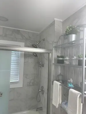 a bathroom with a shower and a bath tub at Beautiful 3 - 4 Bedroom Home Fully Furnished Including Utilities Close to I95 & Train in Stratford