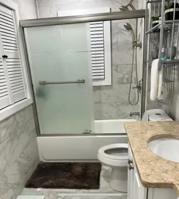 a bathroom with a shower and a toilet and a sink at Beautiful 3 - 4 Bedroom Home Fully Furnished Including Utilities Close to I95 & Train in Stratford