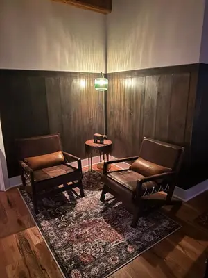 a living room with two chairs and a table at BataviaKill Homestead in Prattsville