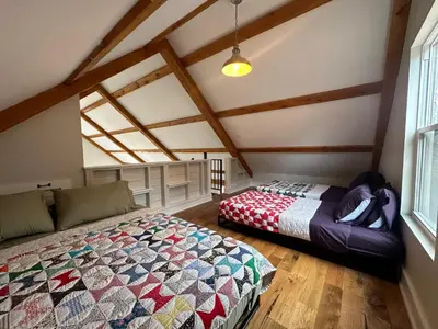 a bedroom with a bed in a attic at BataviaKill Homestead in Prattsville