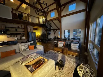 a living room with a couch and a dog in it at BataviaKill Homestead in Prattsville