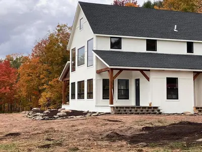 a house under construction in the fall at BataviaKill Homestead in Prattsville