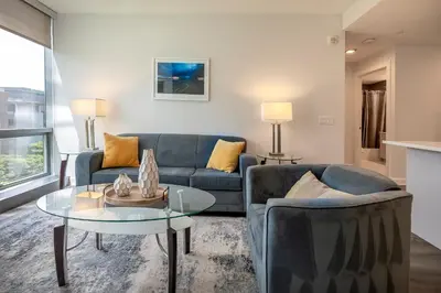 a living room with a couch and a table at Modern Apt Close to Downtown in Stamford