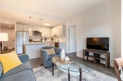 a living room with a couch and a table at Modern Apt Close to Downtown in Stamford