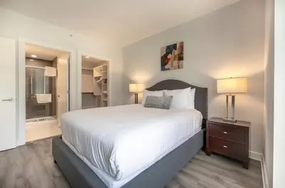 a bedroom with a large bed and a walk in shower at Modern Apt Close to Downtown in Stamford