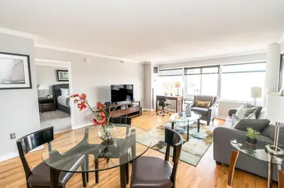 a living room with a table and chairs and a couch at Private Apt Close to Train in Stamford