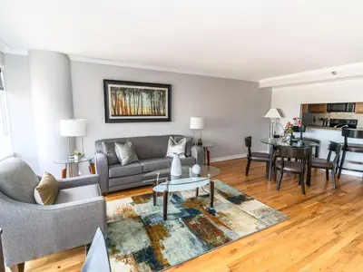 a living room with a couch and a table at Private Apt Close to Train in Stamford