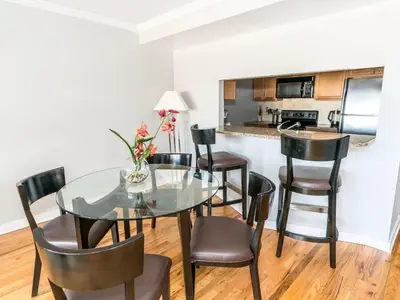 a dining room with a glass table and chairs at Private Apt Close to Train in Stamford