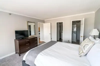 a bedroom with a large bed and a television at Private Apt Close to Train in Stamford