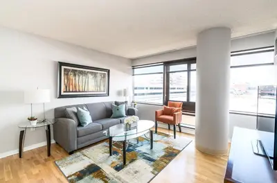 a living room with a couch and a table at Comfy Apt Downtown in Stamford