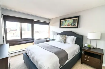 a bedroom with a large bed and a window at Comfy Apt Downtown in Stamford