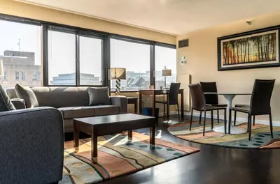 a living room with a couch and a table and chairs at Private Apt Downtown in Stamford