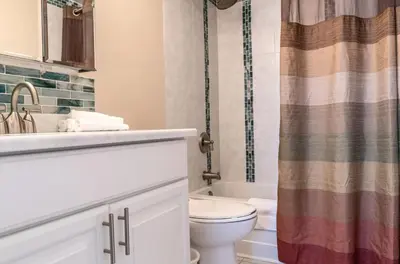 a bathroom with a toilet and a sink and a shower at Private Apt Downtown in Stamford