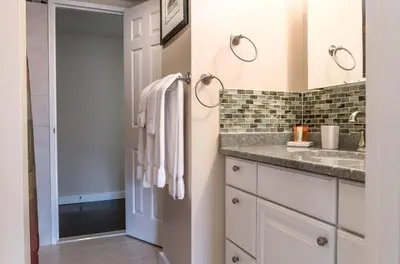 a bathroom with a sink and a mirror at Private Apt Downtown in Stamford