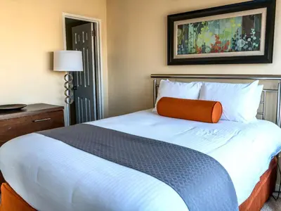 a bedroom with a bed with an orange pillow on it at Private Apt Downtown in Stamford