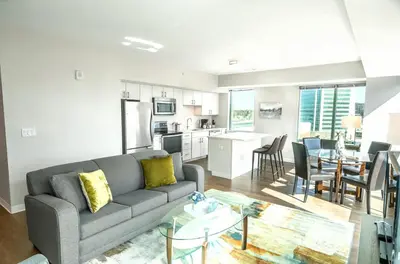a living room and kitchen with a couch and a table at Entire Apt Downtown with Gym in Stamford