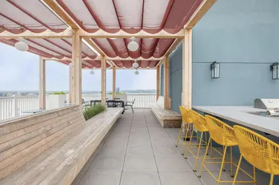 a patio with chairs and a bar with a view at Entire Apt Downtown with Gym in Stamford