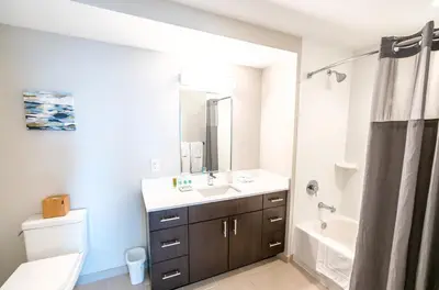 a bathroom with a sink and a tub and a toilet at Entire Apt Downtown with Gym in Stamford