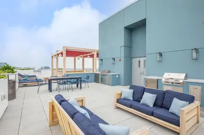 a patio with a blue couch and a table at Entire Apt Downtown with Gym in Stamford