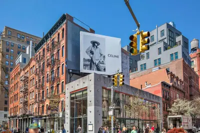 a building with a sign on it in a city at Nolita 2br w wd nr SoHo NYC-955 in New York