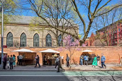 a group of people walking on a sidewalk in front of a brick building at Nolita 2br w wd nr SoHo NYC-955 in New York