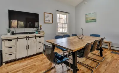 a dining room with a wooden table and chairs at Mountain Dream Brand New Hot Tub Fire Pit in Hunter