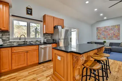 a kitchen with wooden cabinets and a counter top at Mountain Dream Brand New Hot Tub Fire Pit in Hunter