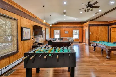 a room with two pool tables and a ceiling fan at Mountain Dream Brand New Hot Tub Fire Pit in Hunter