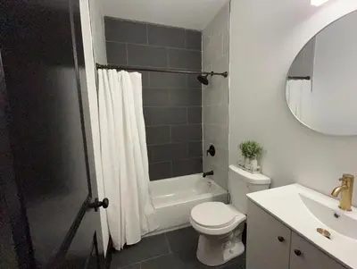 a bathroom with a white toilet and a sink at Apartment Few Minutes NYC and Prudential Center in Newark