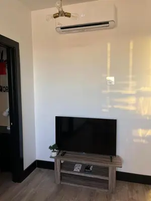 a flat screen tv sitting on a wall at Apartment Few Minutes NYC and Prudential Center in Newark