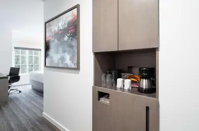 a living room with a kitchen with a cupboard at Hyatt House White Plains in White Plains