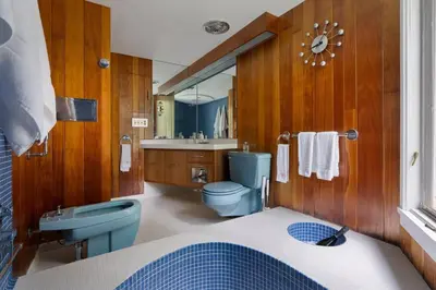 a bathroom with a blue toilet and a sink at Quarry House Mid-Century Modern in Haddam