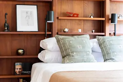 a bedroom with wooden walls and a bed with pillows at Quarry House Mid-Century Modern in Haddam