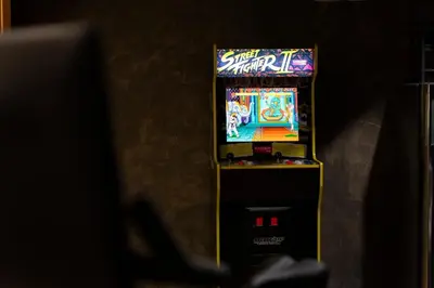 a pinball machine in a room with a game at Quarry House Mid-Century Modern in Haddam