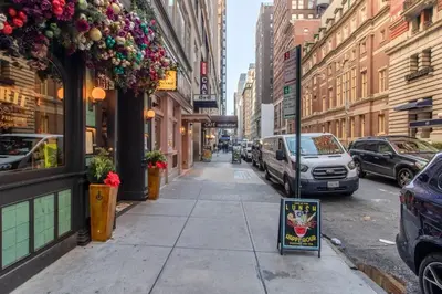 a city street with cars parked on the street at Blueground Midtown gym wd ac nr Rock Ctr NYC-1536 in New York