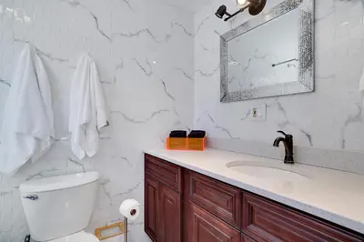 a bathroom with a toilet and a sink and a mirror at 3BD Stevens Universe Theme - Games - Backyard in Tobyhanna