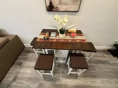 a dining room table with chairs and flowers on it at The Luxury Suite - 1BR with Gym & Office in Paterson