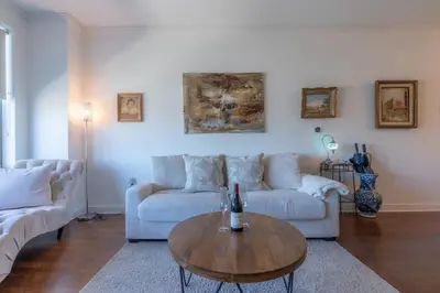a living room with a couch and a coffee table at King Master and Plush Queen near NYC w kitchen, living room plus on-site gym in Jersey City