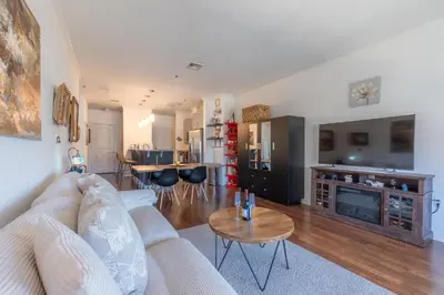 a living room with a couch and a table at King Master and Plush Queen near NYC w kitchen, living room plus on-site gym in Jersey City