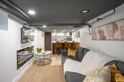 a living room with a couch and a table at Romantic Hideout 1Bedroom Lower Level in Stamford