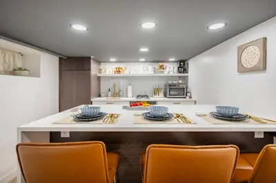 a kitchen with a table with chairs and a counter top at Romantic Hideout 1Bedroom Lower Level in Stamford