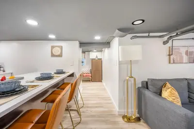 a kitchen and living room with a couch and chairs at Romantic Hideout 1Bedroom Lower Level in Stamford