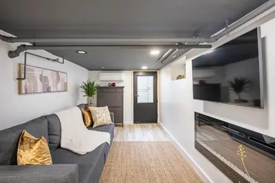 a living room with a couch and a fireplace at Romantic Hideout 1Bedroom Lower Level in Stamford