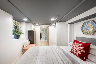 a bedroom with a large bed with a red pillow at Romantic Hideout 1Bedroom Lower Level in Stamford