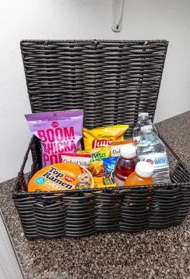 a basket filled with food and drinks on a counter at Pelham Haven Suite in New York in Pelham