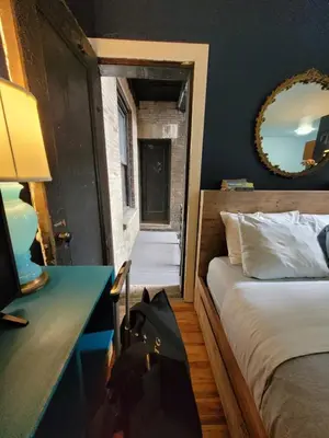 a bedroom with a bed and a desk and a mirror at Private Studio Near Columbia Presbyterian Hospital in New York
