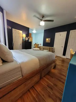 a bedroom with a large bed with two white doors at Private Studio Near Columbia Presbyterian Hospital in New York